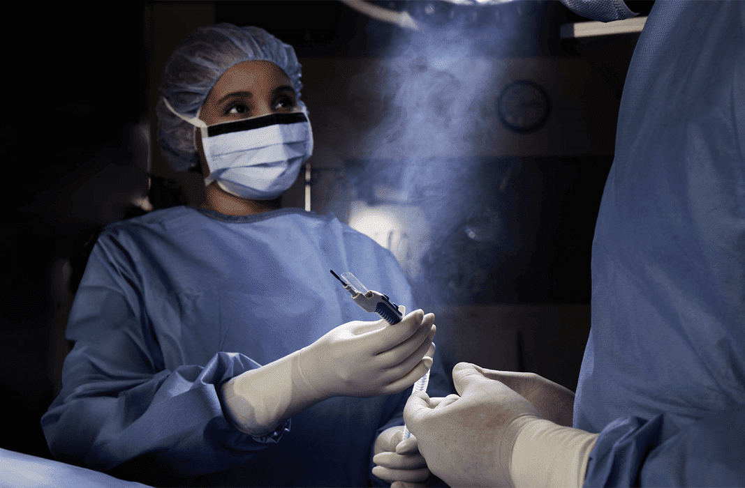 an operating room setting with surgical smoke present in the air