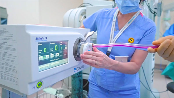 Medical professional setting up AirSeal device