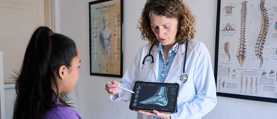 Doctor with patient showing foot x-ray