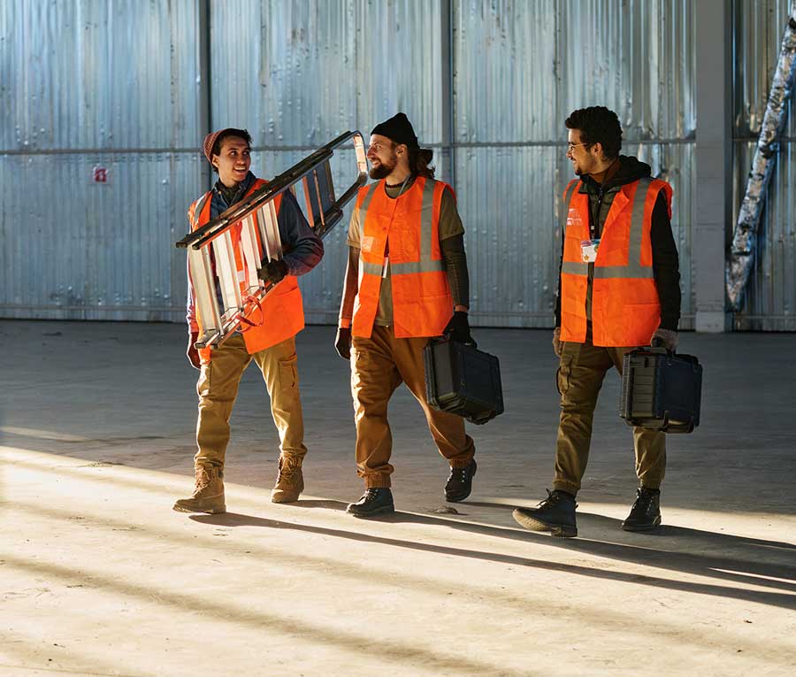 Construction workers wearing orange safety vest preparing for an early shift