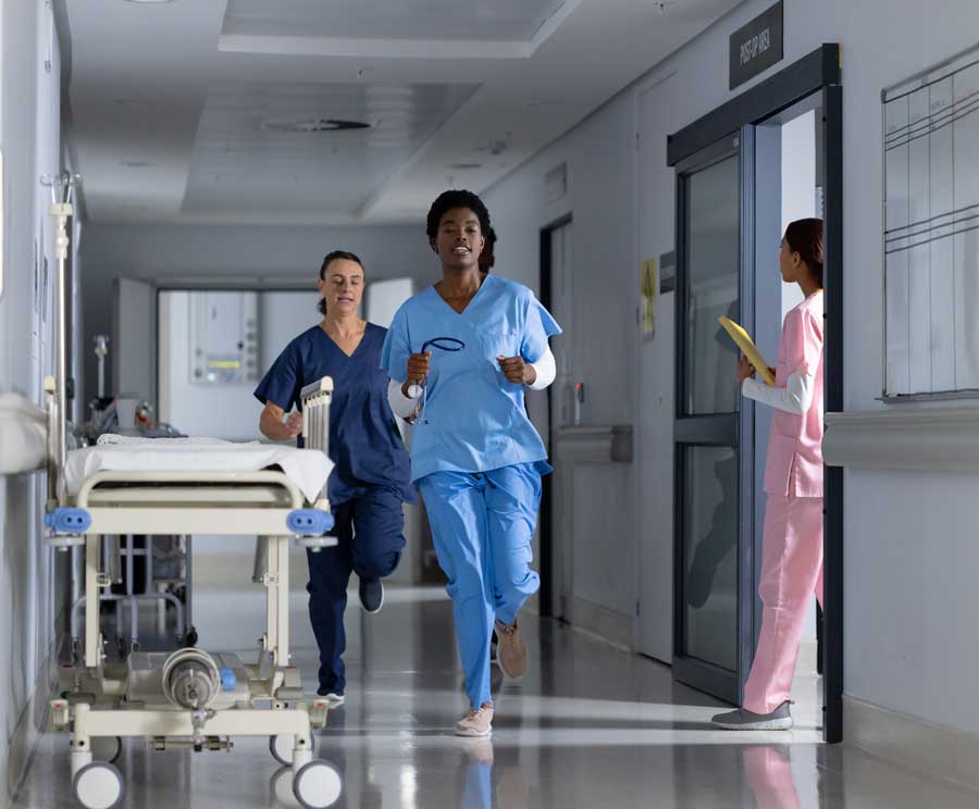 medical professionals rushing dow the hall way