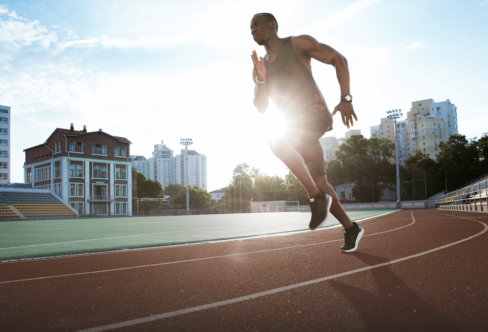 male runner running around a track